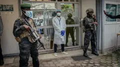 M23 soldiers provide security for di movement authorities for di Rodolphe Mérieux Laboratory, National Biomedical Research Institute (INRB) in Goma, on May 19, 2026 during dia guided visit to di laboratory responsible for analyzing and handling suspected Ebola cases