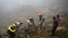Rescue workers search for victims after a giant landslide in Petropolis on 19 February