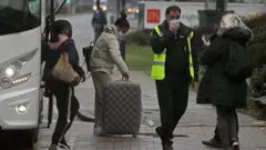 People arrive for hotel quarantine