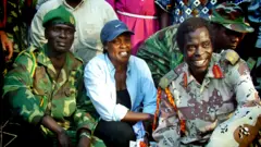 Betty Bigombe (centre) with LRA negotiator Brig Sam Kolo in 2004