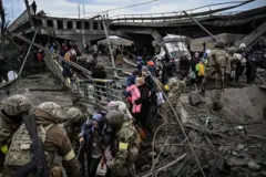 Ukrainians evacuating over a collapsed bridge