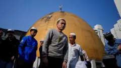 Muslims attend Eid al-Fitr prayers, to mark the end of the holy fasting month of Ramadan at a mosque in Shanghai, China