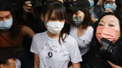 Agnes Chow (centre) leaves prison in Hong Kong. Photo: 12 June 2021