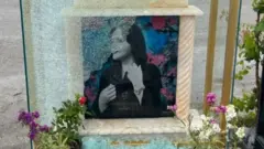 Photograph posted on Instagram by Ashkan Amini showing a broken pane of glass that was covering the tombstone of Mahsa Amini at a cemetery in Saqqez, Iran (21 May 2023)