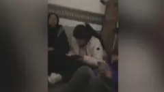 This short video clip sent to the BBC showed the women sitting in the cramped space of a truck filled with banana crates.