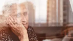 woman sitting alone and looking sadly