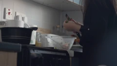 Sara is cooking in the kitchen