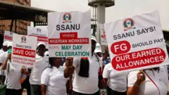 plenti pipo hold flag wit mesaages wey concern workers