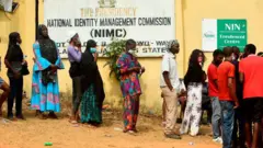 National Identity Management Commission banner wit pipo wey dey line up