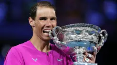 Rafael Nadal celebrates with the Australian Open trophy
