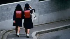 Two girls in school uniform