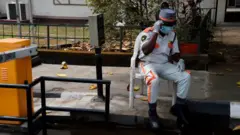 Visitors to one goment hospital collects face masks, hand gloves and have dia hands sanitise as dey walk past di security post entrance in Lagos, on February 28, 2020