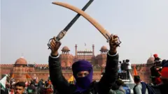 A farmer holds a sword during a protest against farm laws introduced by the government, at the historic Red Fort in Delhi, India, January 26, 2021