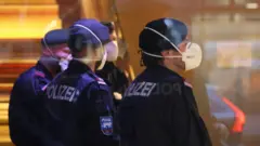 Police wearing masks at a hotel in Innsbruck, Austria