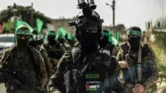 Hamas militiamen carrying weapons