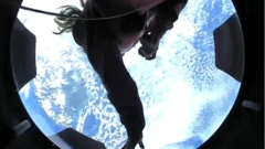 Amateur astronaut Haley Arceneaux in front of a view of the Earth from space