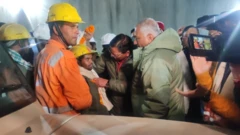 The first worker to emerge from the tunnel (handout image)