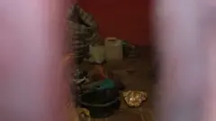 Police had locked the hut but items used in rituals can be seen through a crack in the door