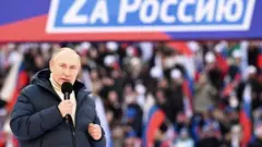Russian President Vladimir Putin gives a speech at a concert marking the eighth anniversary of Russia's annexation of Crimea at the Luzhniki stadium
