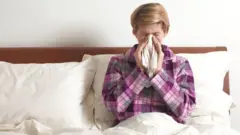 Woman in bed with a cold