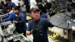 Varios obreros en una planta de manufacturas en México