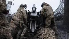 An artillery unit from Ukraine's Khartiia Brigade prepare to fire a US-made M101A1 Towed Howitzer near a frontline in the Kharkiv region, Ukraine