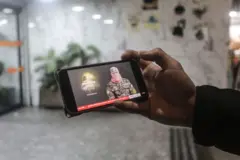 Un hombre palestino ve en su teléfono un discurso de Obeida a principios de 2025.