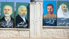 Pinturas em uma parede com os rostos de ex-líderes do Hamas: Ismail Haniyeh, Yahya Sinwar, Mohammed Deif e o xeque Ahmed Yassin