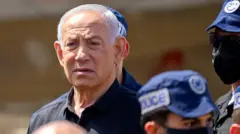 Netanyahu looks on while surrounded by police officers with caps on while standing outdoors at the site of a strike in Dimona, Israel on Sunday.