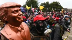 A Trump bust being held up during the day of the riot at the US Capitol 
