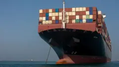  A ship remains anchored on May 16, 2026 in the Strait of Hormuz near Larak Island, Iran