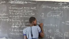 Young school girl wey dey solve mathematics problem