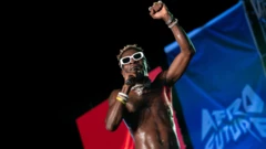 Shatta Wale performing at an event barechested
