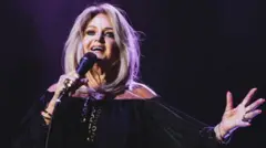 Bonnie Tyler sings into a mic
