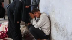 Une femme réconforte le parent d'une des victimes de la frappe aérienne à Gaza, la principale ville de la bande
