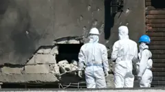 Forensic investigators examine the location of impact after a Russian drone struck an apartment building in Galati, eastern Romania