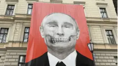 Banner of Russian President Vladimir Putin with 'death mask' on his face, next to the Moscow embassy in Riga, Latvia