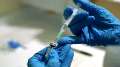 A needle is filled from a phial of Pfizer/BioNTech Covid-19 vaccine