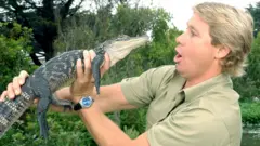 Steve Irwin with a baby crocodile