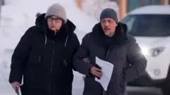 Alexei Navalny's mother Lyudmila and lawyer Vasily Dubkov (right) in a town close to the penal colony where the opposition leader died