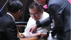 เพื่อนร่วมสภาช่วยกันปฐมพยาบาลนายวิสาร เตชะธีราวัฒน์ หลังกรีดเลือดกลางสภา