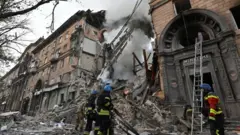 Rescuers work at the site of a missile strike in Zaporizhzhia, southern Ukraine. Photo: 6 October 2022