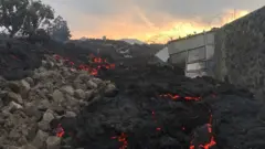 Smouldering ashes are seen early morning in Goma in the East of the Democratic Republic of Congo on 23 May 2021 following the eruption of Mount Nyiragongo