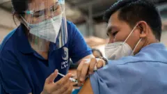 Health worker receives Pfizer booster shot in Quezon City, Philippines - November