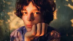 Child resting their face in their hand