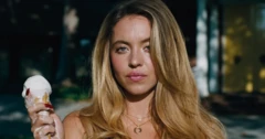 Uma mulher loira segurando um sorvete