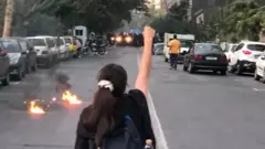 Une manifestante face à la police.