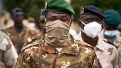 Colonel Assimi Goita, president of the CNSP (National Committee for the Salvation of the People), arrives at the funeral of former Mali President General Moussa Traore in Bamako on September 18, 2020.