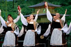 Mulheres dançam com roupas típicas italianas