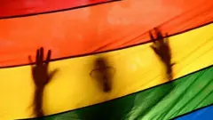 Pesin dey behind LGBT logo